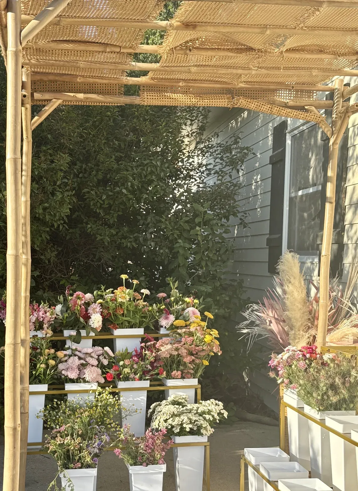 The farm stand under the pergola, stocked with fresh flowers